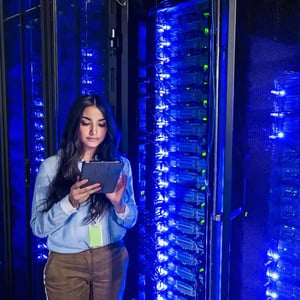 Filecoin DeStor female data center technician in blue glowing data center